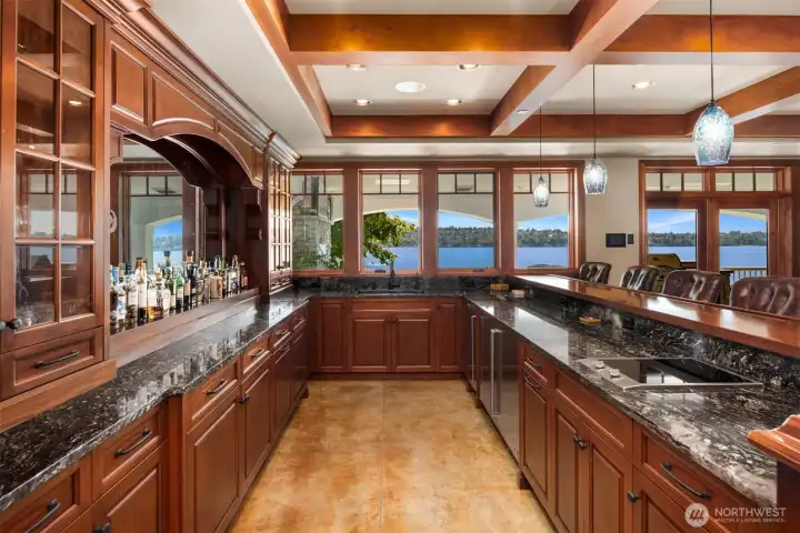Full bar with expansive views of lake, mirror/tv on bar wall.