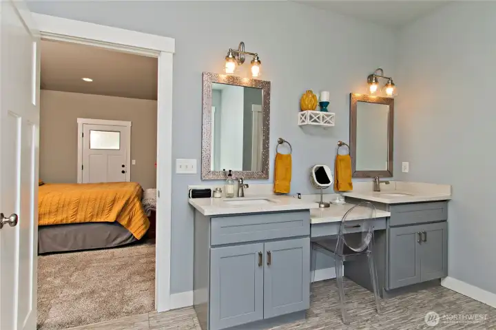 Primary bathroom with dual vanities.