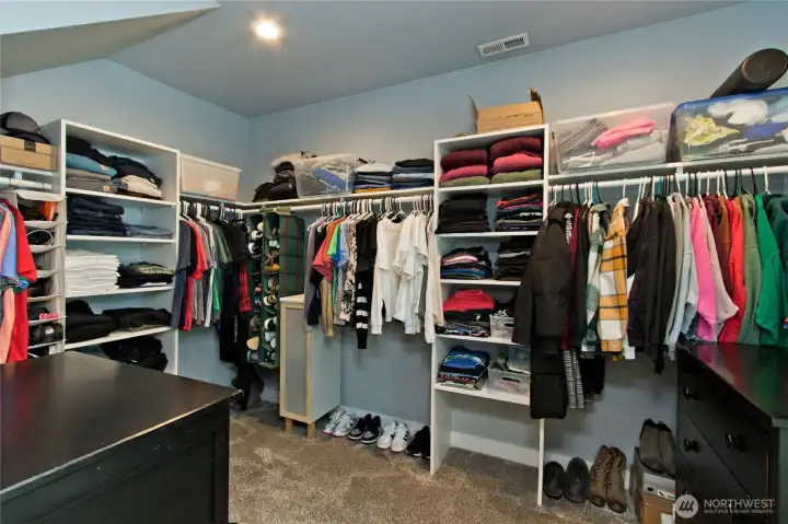 Large walk-in closet with built-in shelving.