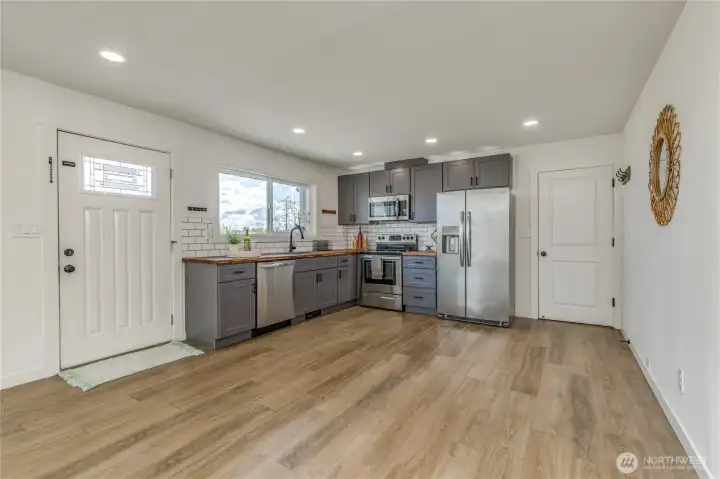 Updates throughout the home including this modern kitchen with newer stainless appliances.
