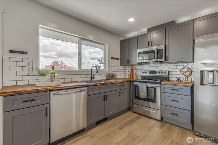 Rich butcher block counters and classic subway tile backsplash