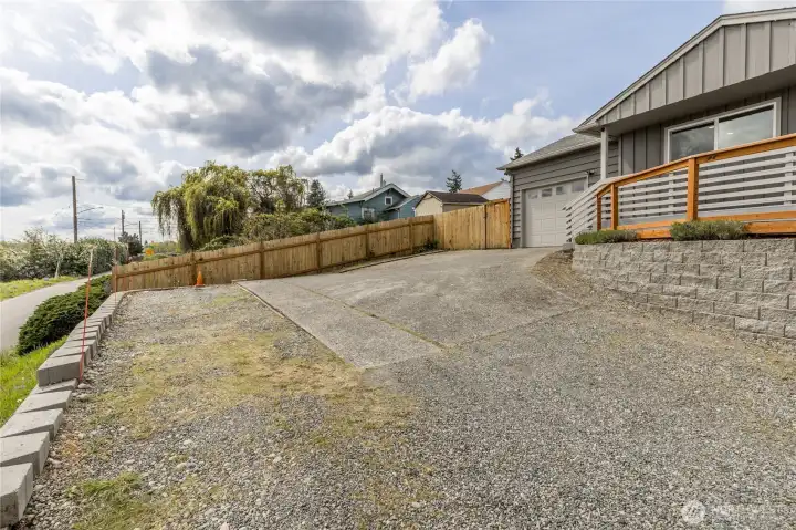 Generous driveway with additional side parking area, providing easy access to the garage and plenty of room for visitors or your RV/boat