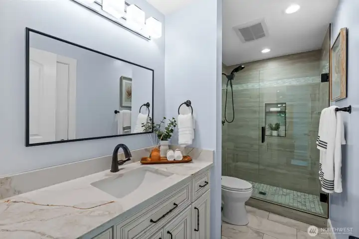 Main floor bathroom with beautiful tile shower