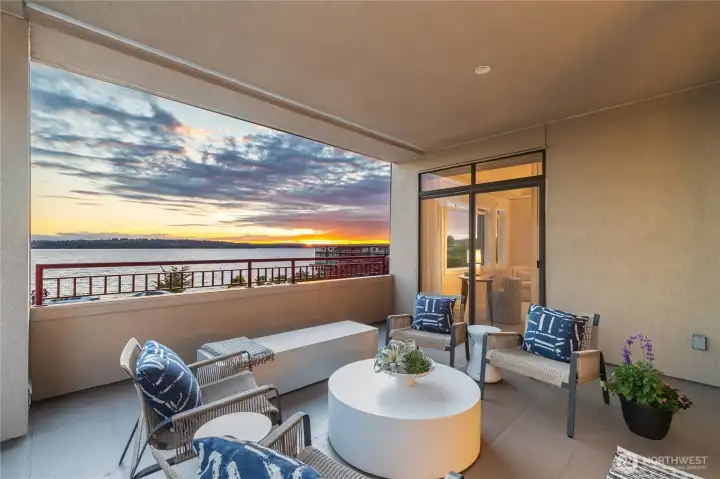Expansive covered patio offering panoramic views and vibrant sunsets, seamlessly extending from both the living room and the primary bedroom. Expansive covered patio offering panoramic views and vibrant sunsets, seamlessly extending from both the living room and the primary bedroom.
