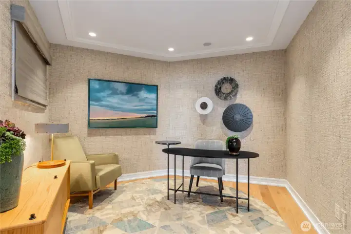 A refined office and den with direct waterfront views, offering an exceptional space to work, read, or simply take in the scenery. A refined office and den with direct waterfront views, offering an exceptional space to work, read, or simply take in the scenery.