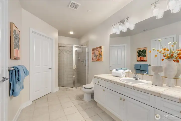 Second bedroom with an ensuite bathroom featuring a walk-in shower and a walk-in closet. Second bedroom with an ensuite bathroom featuring a walk-in shower and a walk-in closet.