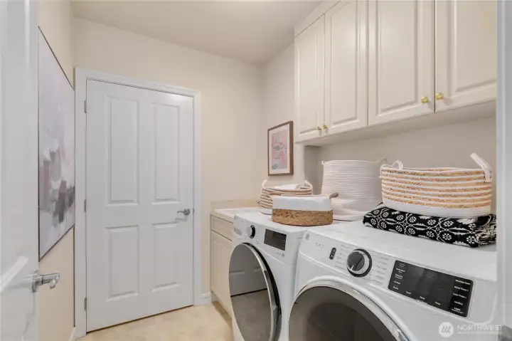 Laundry room featuring a new washer and dryer, with convenient access to the furnace and air conditioning room. Laundry room featuring a new washer and dryer, with convenient access to the furnace and air conditioning room.