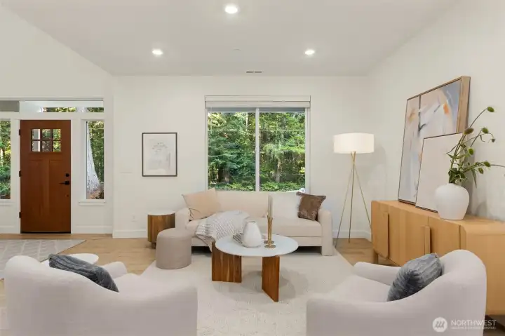 Beautiful light, wide-plank laminate flooring extends throughout the main level, adding warmth, durability, and a seamless flow that complements the home's bright, contemporary design. Beautiful light, wide-plank laminate flooring extends throughout the main level, adding warmth, durability, and a seamless flow that complements the home's bright, contemporary design.