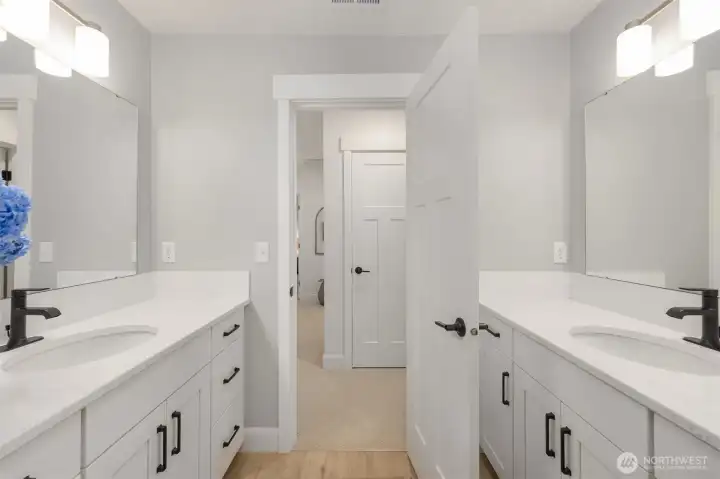 The upstairs bathroom is thoughtfully designed with dual vanities and a separate enclosed toilet area. The upstairs bathroom is thoughtfully designed with dual vanities and a separate enclosed toilet area.