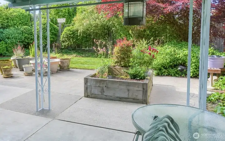 Mature landscaping with raised beds and level yard.