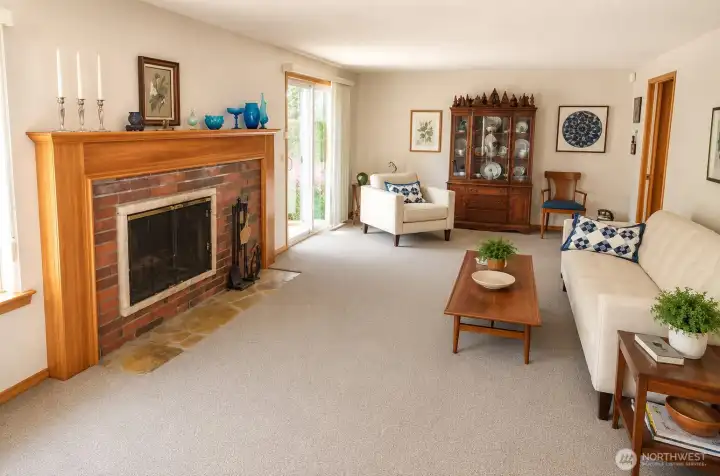 Beautiful cozy fireplace with slate hearth, custom window treatments and pocket door to kitchen.