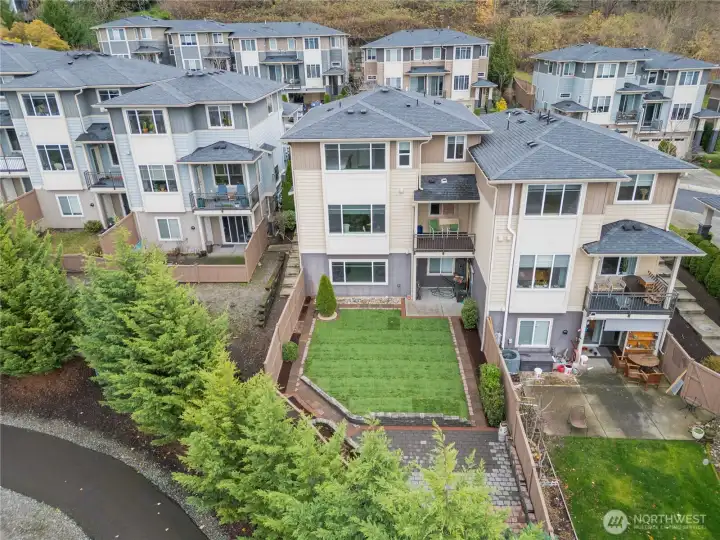 Beautifully landscaped backyard with a grassy area for play.