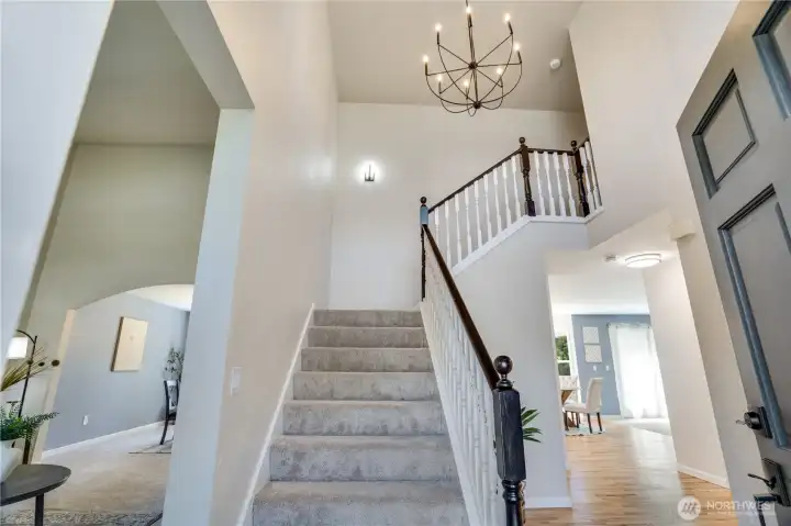 Step inside to a soaring two-story foyer that immediately opens to the home's inviting layout, where formal and everyday living spaces are thoughtfully connected.