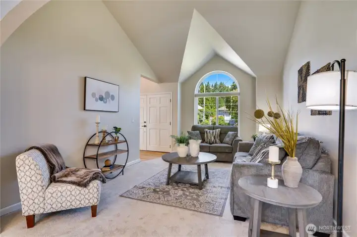 Natural light pours through the dramatic arched picture window, highlighted by updated windows and new trim installed in 2022.