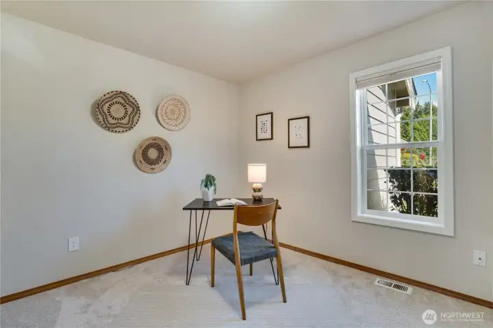 A dedicated main-floor office overlooking the front yard offers a comfortable space for working from home, creative projects, or quiet reading.