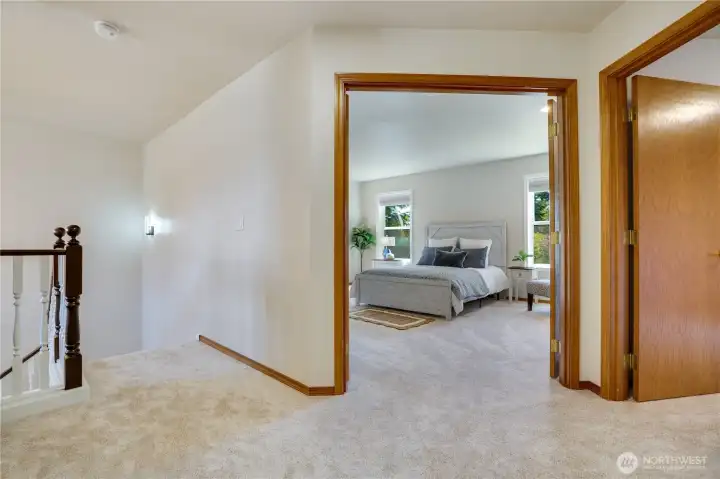 Double doors lead to the expansive primary suite, while new carpeting completed in 2026 adds comfort throughout the upper level.