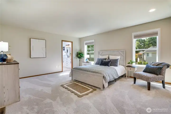 The generous primary suite offers plenty of room to unwind, with backyard views, abundant natural light, and direct access to the beautifully remodeled primary bath.