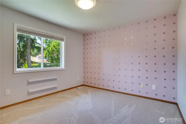 Bright backyard views and updated windows with new trim (2022) create a comfortable and versatile secondary bedroom.