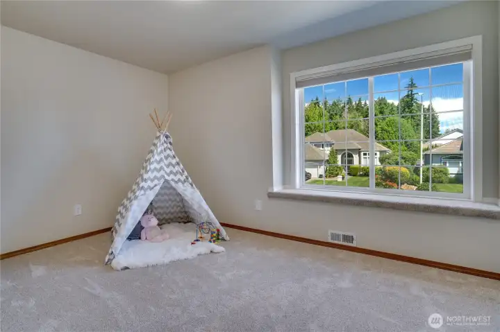 Window seating, abundant natural light, and updated windows make the third bedroom an inviting space to personalize.