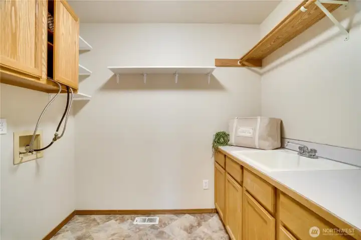 Conveniently located upstairs, the dedicated laundry room includes cabinetry, counter space, and storage to help simplify everyday routines.