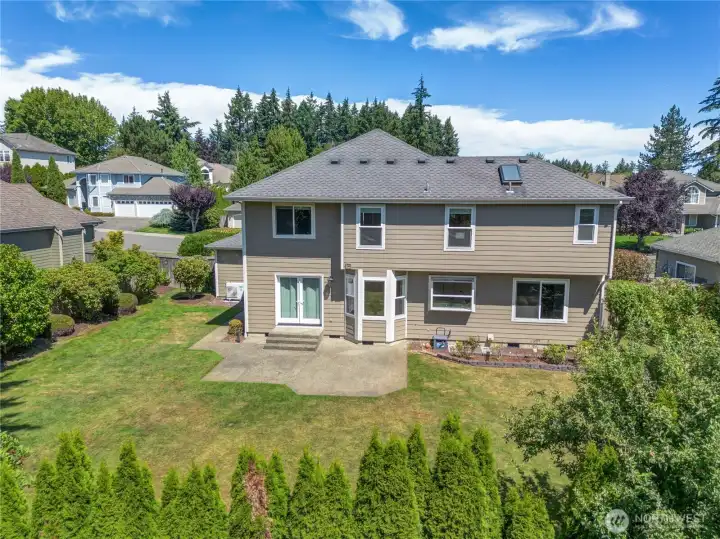 The fully fenced backyard offers a generous lawn, mature landscaping, and a patio ready for everything from summer barbecues to quiet evenings outdoors.