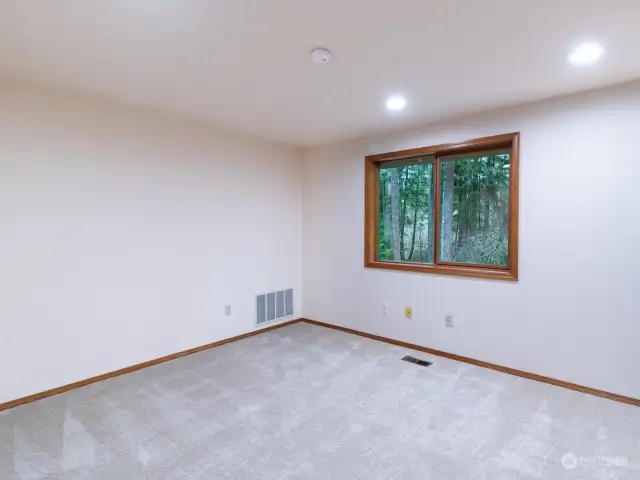 Large top floor guest room on back of house with new carpet and double closets.