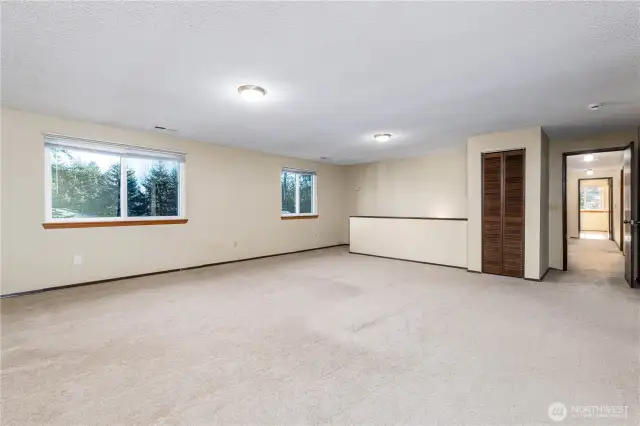 Another view of the bonus room with hallway to bedrooms.