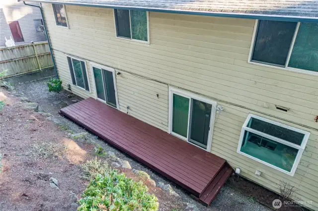 Back yard, porch, and two sliding glass doors.