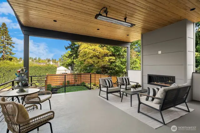 The back deck located off of the kitchen with easy care waterproof decking, knotty pine ceiling, electric fireplace, ceiling heater and TV outlet. The stairs go down to the yard and driveway.