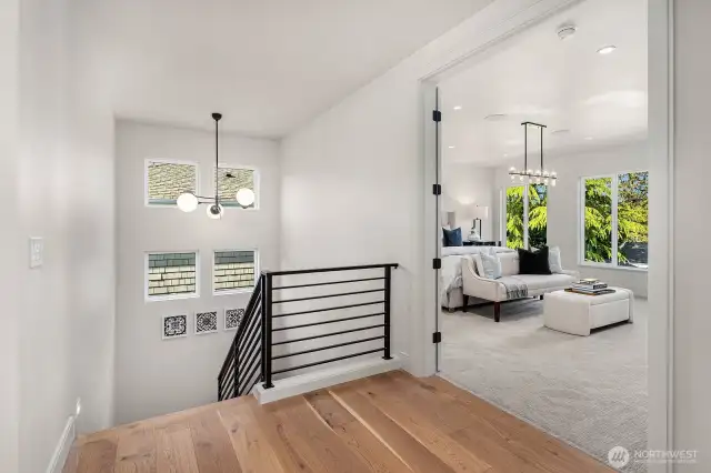 Ascend to the top floor, where you'll discover the expansive Primary Bedroom, featuring a custom-designed bed wall and oversized windows that frame breathtaking territorial views. This serene retreat offers the perfect blend of luxury and tranquility.