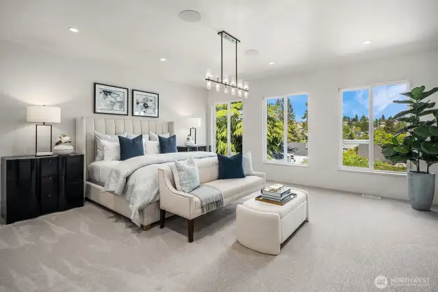 From the Primary Bedroom, enjoy a stunning view towards the elegant beverage station, cozy electric fireplace, and stylish barn door that leads to the bathroom, creating a seamless blend of comfort and sophistication.