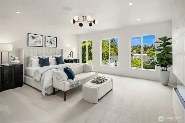 From the Primary Bedroom, enjoy a stunning view towards the elegant beverage station, cozy electric fireplace, and stylish barn door that leads to the bathroom, creating a seamless blend of comfort and sophistication.