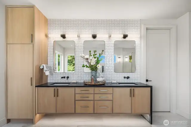 The Primary Bathroom sink area is beautifully designed with custom storage and sleek linen cabinets, offering both elegance and practicality to keep your essentials organized in style.