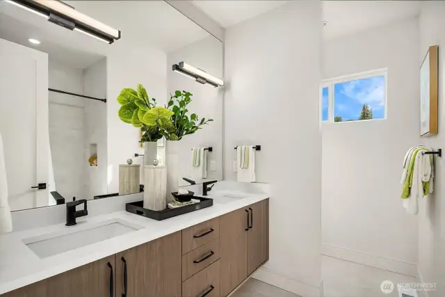 The 2nd-floor Hall Bath is a stunning retreat, featuring double sinks, a tub/shower combination, and a private toilet area for added convenience. Elegant tile floors, floating cabinets, and sleek granite countertops elevate the space, making it both stylish and functional.