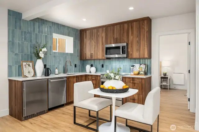 The Lower-Level Guest/ADU unit boasts a fully equipped kitchen, featuring elegant Belmont cabinets, sleek granite countertops, and top-of-the-line appliances, including a full oven, microwave, sink and a dishwasher. This kitchen is both functional and stylish, perfect for preparing meals with ease.