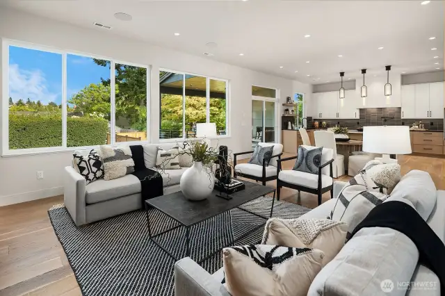 A view from the great room through the dining area towards the kitchen with slider to the covered deck.