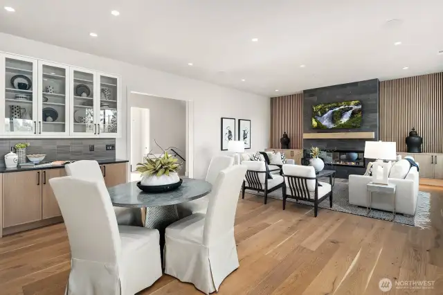 Another view from the kitchen to the dining area and great room. Featuring the beverage station with built in display shelves above.