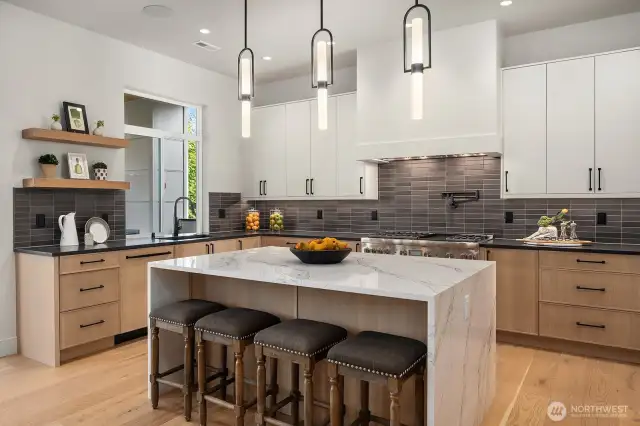 Kitchen Features include: Full U Shaped Kitchen with center Island. Custom Belmont Cabinets with self closing drawers. Quartz Counter tops, Thermador double oven with 6 gas burner plus griddle and Pot filler. Electrolux 64 inch freezer/refrigerator, Thermador Microwave Drawer in island and Thermador Dishwasher located next to the sink.