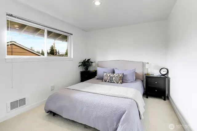 The primary bedroom is light-filled and cozy.