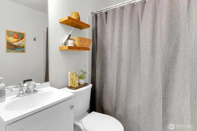 This full bath on the upper level features a clean design and easy access from all bedrooms.