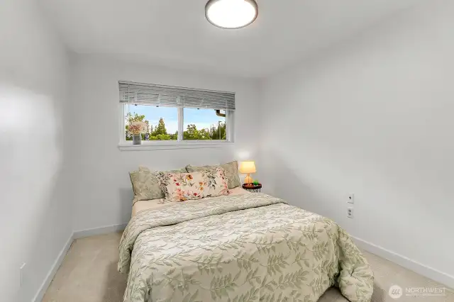 Comfortable and spacious bedroom features ample natural light and space to unwind.