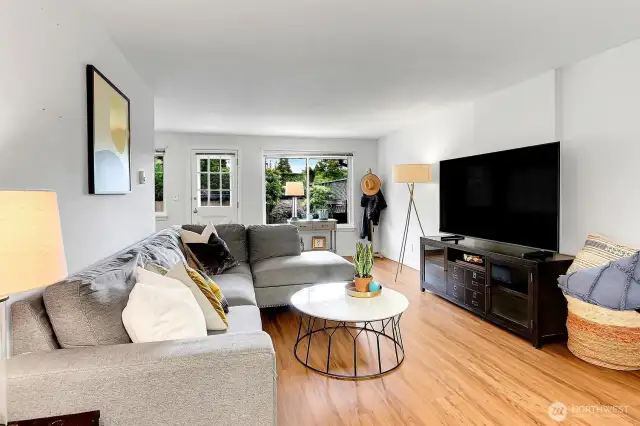 Spacious and inviting living room with abundant natural light, perfect for movie nights or cozy gatherings.