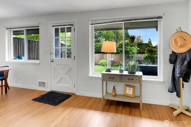 Step outside to the backyard through this charming backdoor framed by garden views.