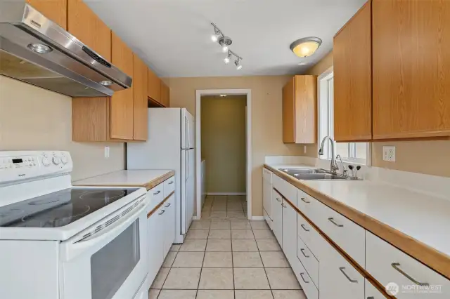 Galley kitchen. Laundry/utility room in the distance