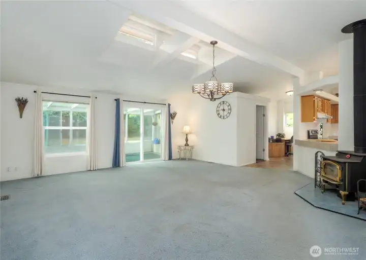 Living room with sunroom and woodstove