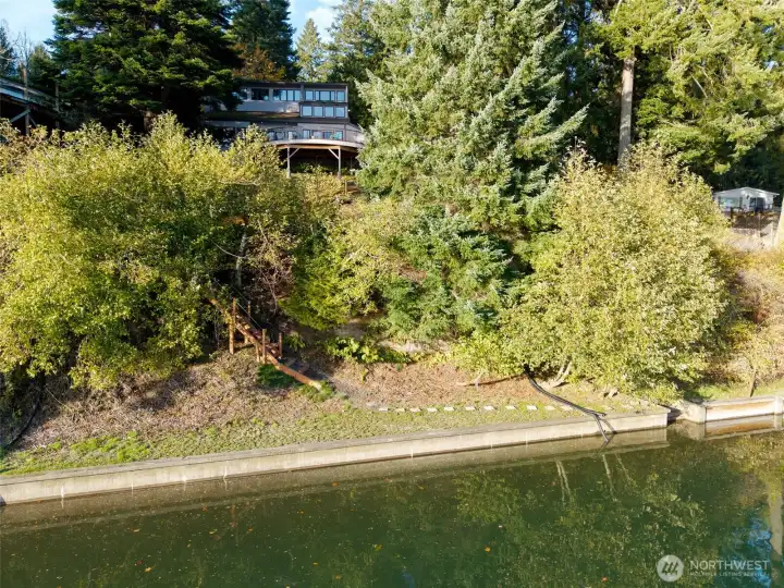 Imagine sunny summer afternoons with your lawn chairs and kayaks during high tide, on this wide, level lawn atop the bulkhead. The concrete stairs lead to a wide, smooth pebble beach at lower tides.  Fun any time of year!
