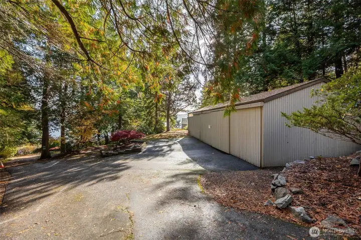 At the top entrance to the property, the extra large storage, shop space sits on a level terrace with some turn around space.  Water and electricity are available to the sturcture. A small portion of the upper entrance is shared.