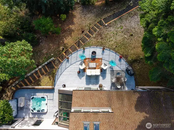 Aerial views of the deck highlight the space and options.  The recently constructed traversing path to the beach stairs features gentle rise steps, hand rails, solar lights and tension wire between treated wood posts.  Amazing.