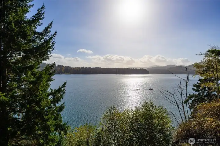 The long view of Eld inlet toward Mud Bay and the south.  The winter afternoon sun gently warms the property amid fall colors and sparkling water.  Take a quiet Kayak ride or drop a buoy, or your anchor for motor boating.