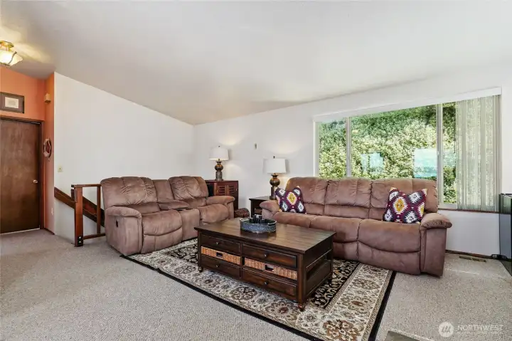 Spacious & bright, open concept living area with vaulted ceiling.
